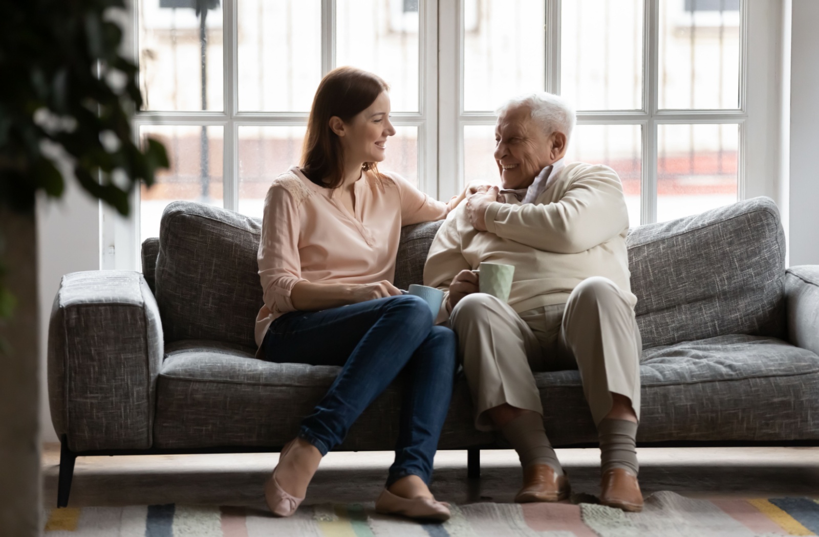 An adult child is patient and loving with their senior parent's memory loss during their visit.
