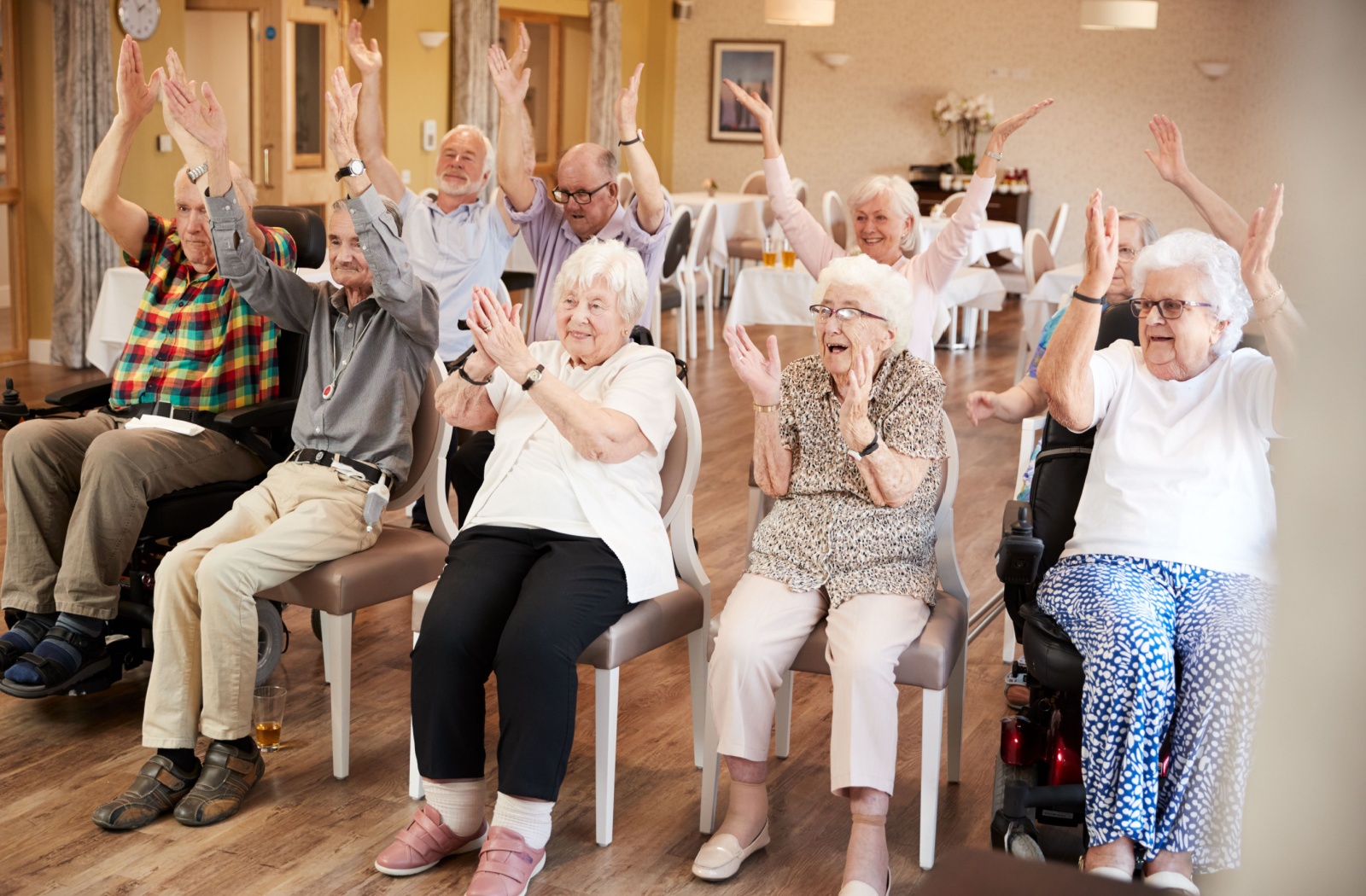 A group of seniors participating in a group game during an organized event with their senior living community.
